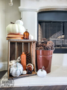 Learn how to make DIY giant paper leaf garland for your fall mantel or fall decorating. This budget garland idea is perfect to add a warm touch of fall to your home and the tutorial is so easy! Mix in some white pumpkin decor, gathered ribbon garland and cozy books for a cozy fall decor idea! #fallvibe #papergarland #papercraft