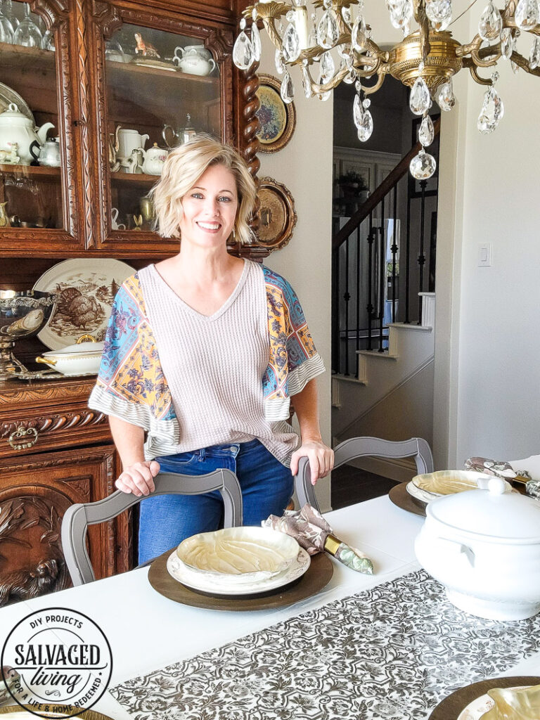 Thrifted finds and dollar store items come together for a beautiful fall table that looks expensive but isn't! I love a good mix of old and new, thrifted and found for a cozy fall table that I can be proud of. If you wonder how to set the table for Thanksgiving this is a great DIY table runner idea for you! #falltablescape #thanksgivingtable #stencilpidea #DIYtablecloth