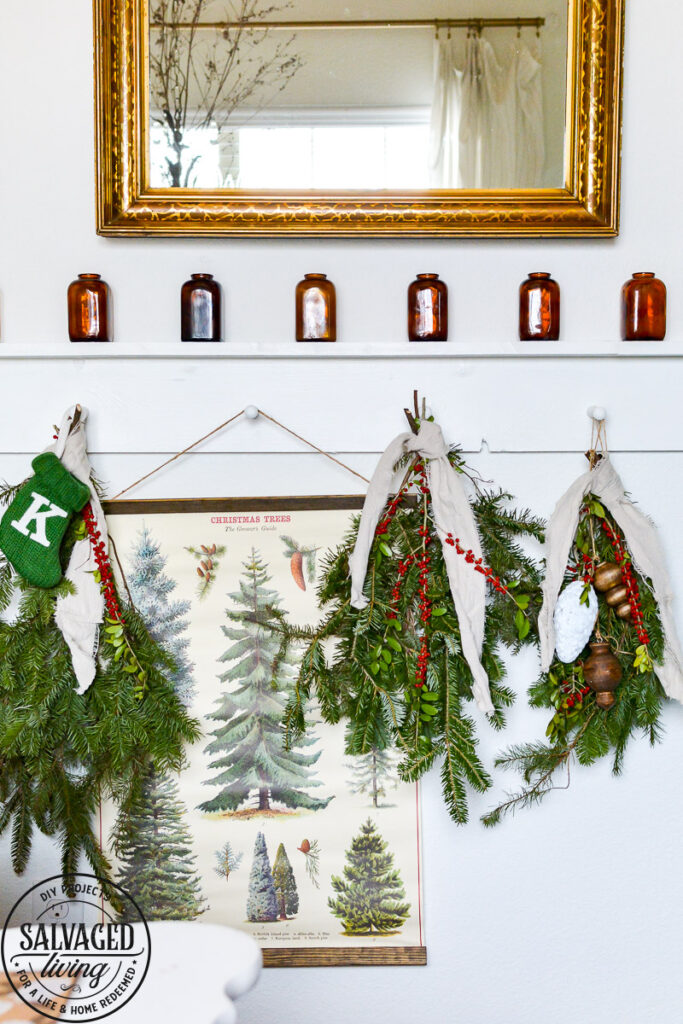 It's Christmas in the dining room, we decorated the peg board with vintage finds and real tree trimmings for an affordable and stylish Christmas feel on a budget. This peg board decorated for Christmas has all the holiday feels for a rustic, neutral Christmas decor vibe. #naturalChristmas #RusticChristmas #vintageChristmas #brownChristmas