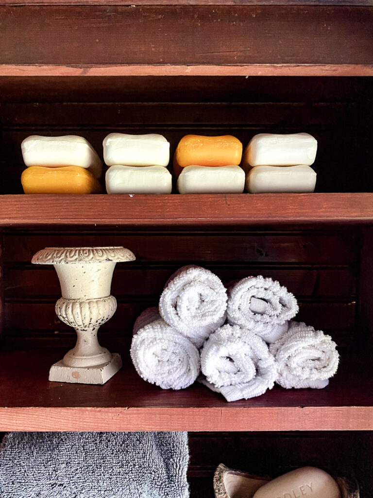 a thrifted cabinet found at a garages sale is perfect for a cozy bathroom upgrade, come see how I decorated this garage sale cabinet for function and style. #bathroomdecor #vintagebathroomstyle #cozybathroom