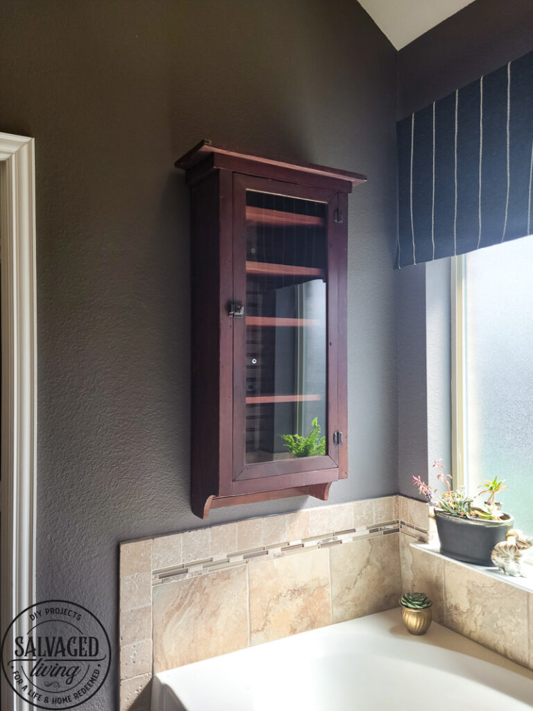 a thrifted cabinet found at a garages sale is perfect for a cozy bathroom upgrade, come see how I decorated this garage sale cabinet for function and style. #bathroomdecor #vintagebathroomstyle #cozybathroom
