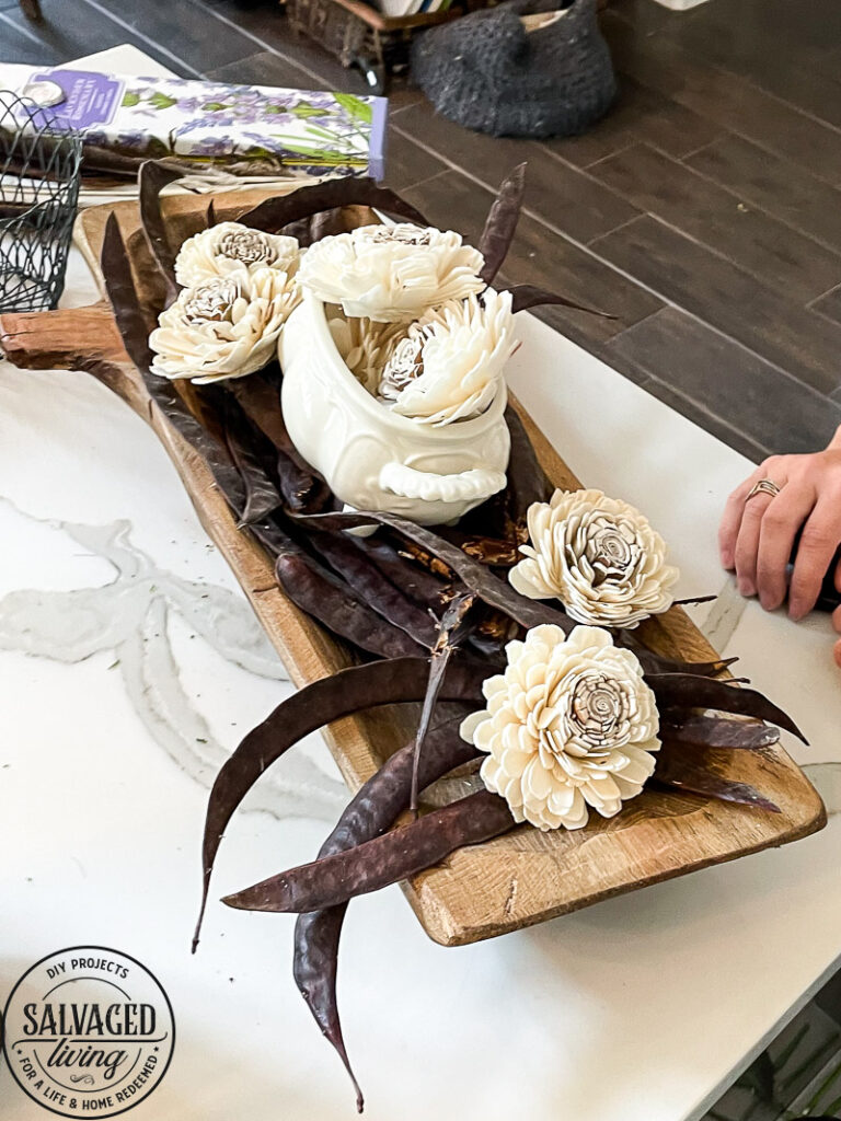 how to decorate a dough bowl with nature and vintage items. Here are 19 ways to decorate your dough bowl for a rustic vintage farmhouse style. These versatile decorating ideas are sure to give you lots of dough bowl inspiration. #doughbowldecor #vignetteideas #smallspacedecor #vintagedecor #cozyhome