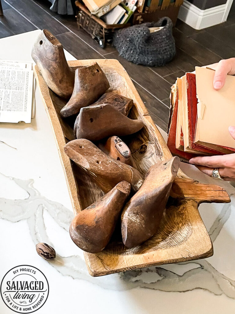 how to decorate a dough bowl with nature and vintage items. Here are 19 ways to decorate your dough bowl for a rustic vintage farmhouse style. These versatile decorating ideas are sure to give you lots of dough bowl inspiration. #doughbowldecor #vignetteideas #smallspacedecor #vintagedecor #cozyhome