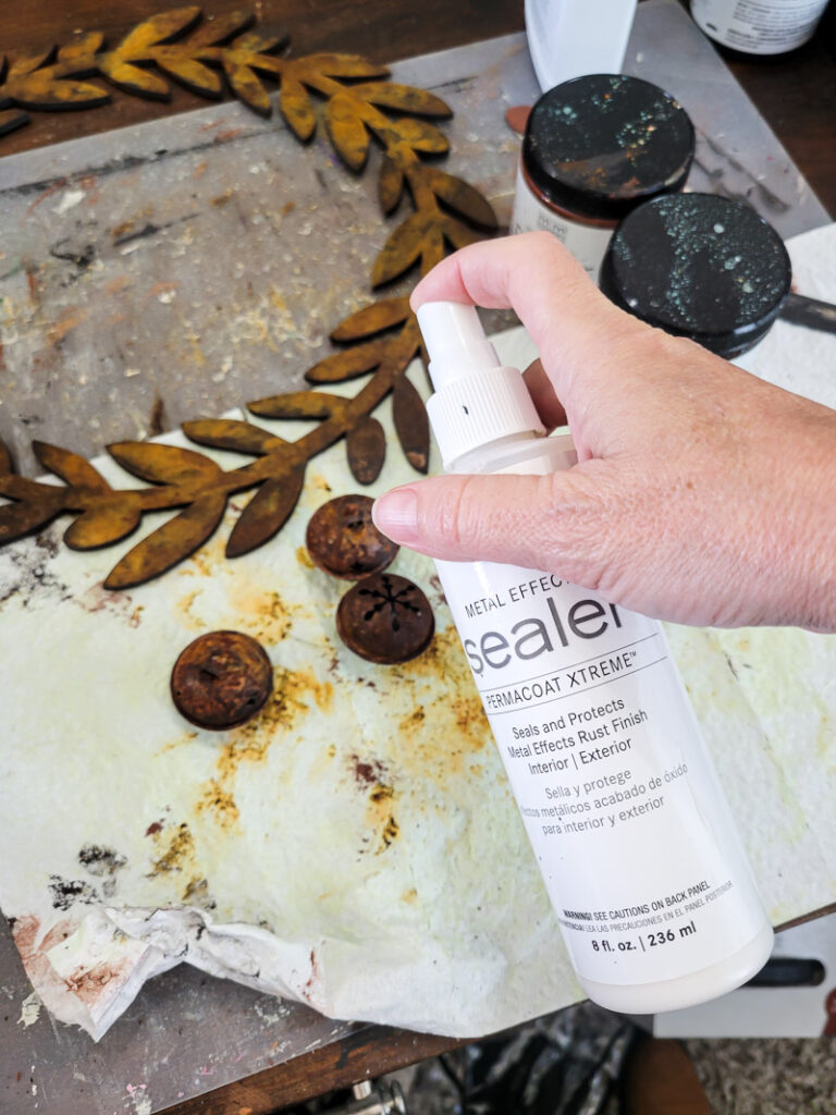 Learn how to rust wood or rust any surface with this amazing product and technique. Rust new things like wood and dollar store bells for gorgeous decor that feels old and vintage. You can make new things old with rust! #DIYdecor #rustychippy #rustfinish #painting technique #paintideas