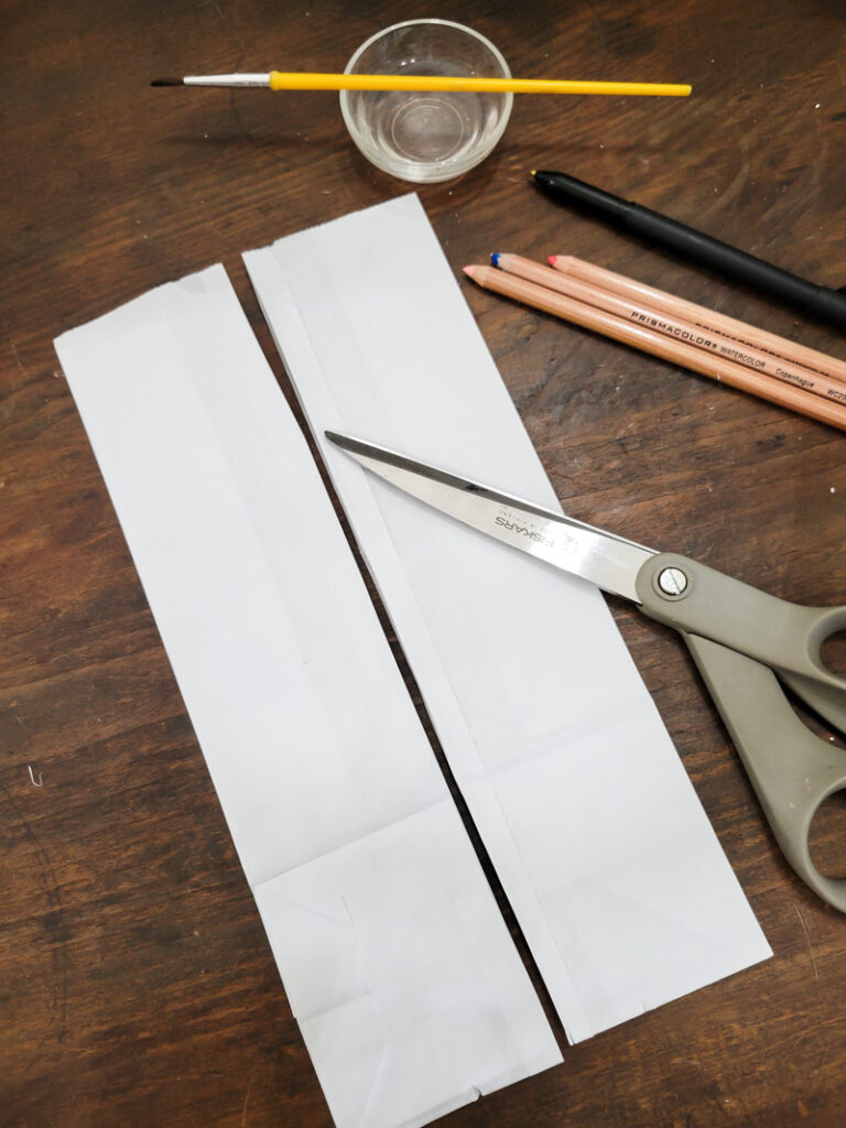 Use a lunch sack to create the cutest DIY utensil holders for Easter! This is the perfect craft to do with your kids, and use them all season before trashing them-- guilt free! #kidcraft #easterdiy #easyeastercraft