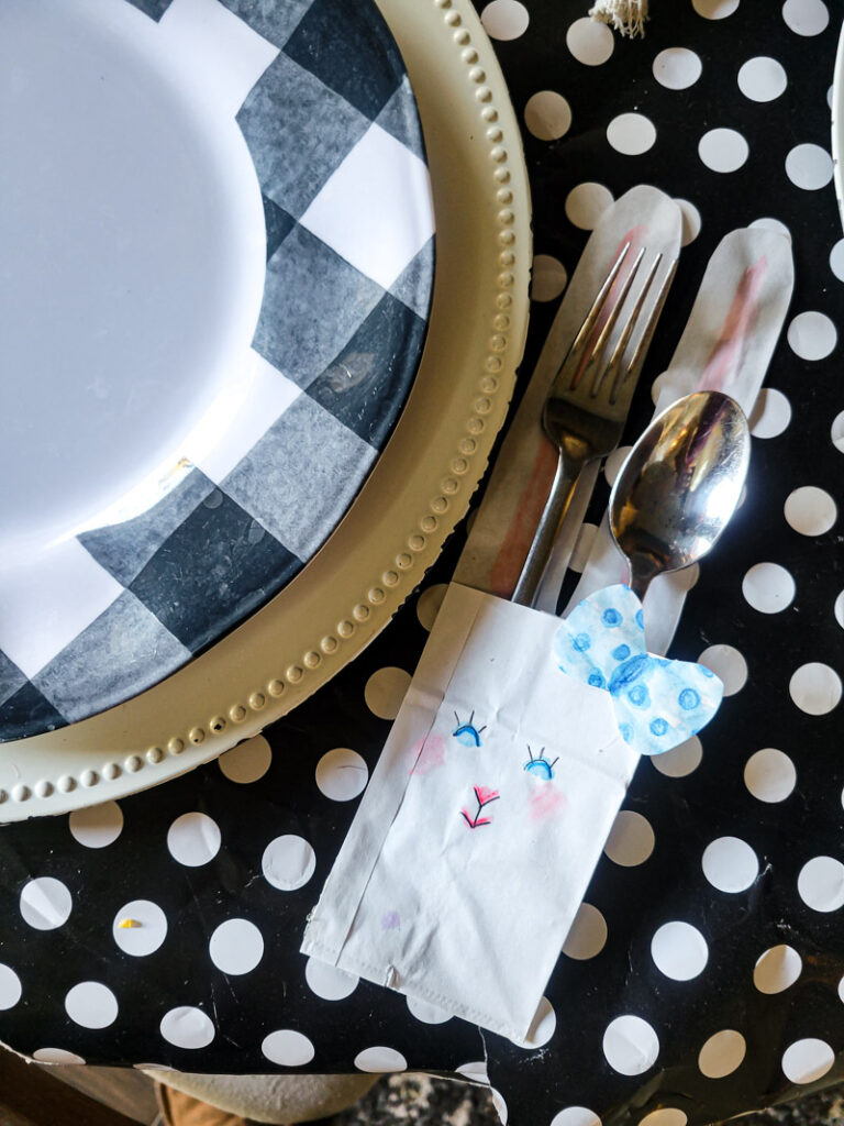 Use a lunch sack to create the cutest DIY utensil holders for Easter! This is the perfect craft to do with your kids, and use them all season before trashing them-- guilt free! #kidcraft #easterdiy #easyeastercraft