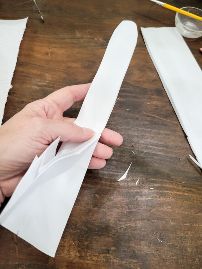 Use a lunch sack to create the cutest DIY utensil holders for Easter! This is the perfect craft to do with your kids, and use them all season before trashing them-- guilt free! #kidcraft #easterdiy #easyeastercraft