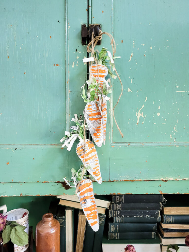 Using just a few simple supplies, you can make these gorgeous stuffed carrots for Easter and use them for years to come! #papercraft #easterdiy #budgetfriendlyeasterdecor #paperdiy