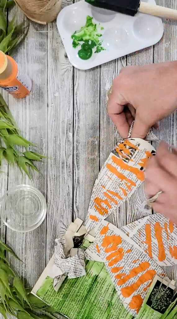Using just a few simple supplies, you can make these gorgeous stuffed carrots for Easter and use them for years to come! #papercraft #easterdiy #budgetfriendlyeasterdecor #paperdiy