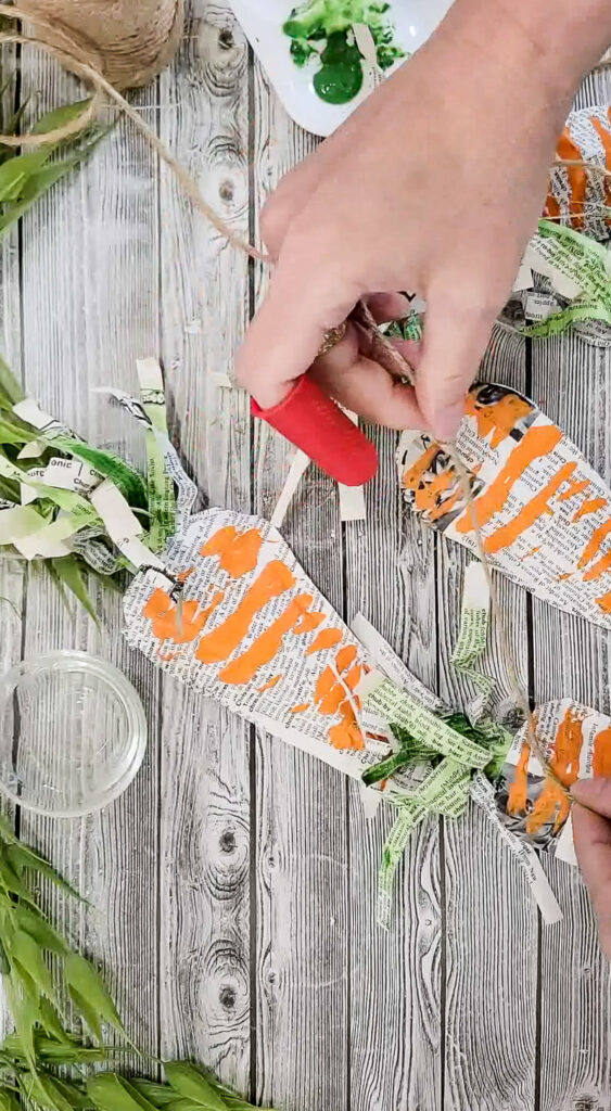 Using just a few simple supplies, you can make these gorgeous stuffed carrots for Easter and use them for years to come! #papercraft #easterdiy #budgetfriendlyeasterdecor #paperdiy
