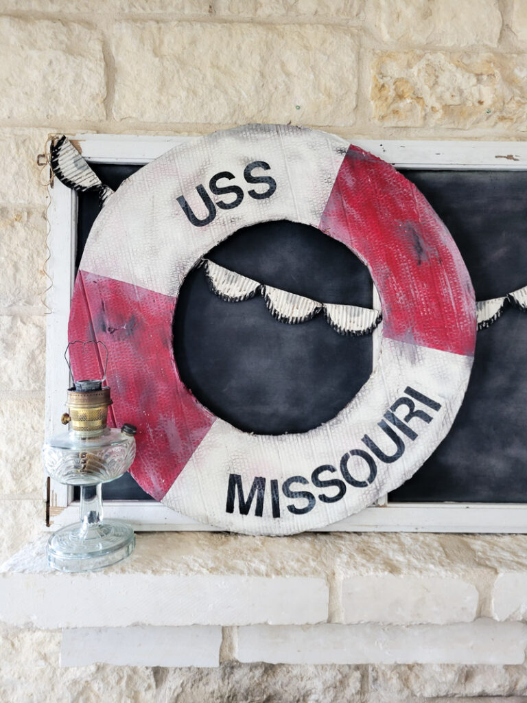 Make a life-size life preserver for vintage summer decorating. This large cardboard project will add a vintage vibe to your beach house, summer vignette or nautical decor motif. So easy and super budget-friendly. #budgetsummerdecor #beachtheme #vintagestylesummer