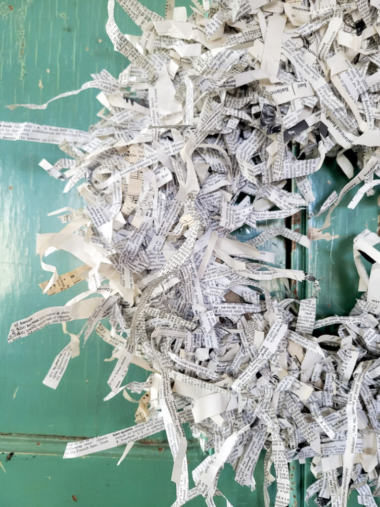 This is the easiest paper craft! Make a precious shredded paper wreath from paper and cardboard. Add a vintage feel to your home on a super tight budget. This decor project literally cost close to nothing! #DIYwreath #cardboardwreath #paperwreath