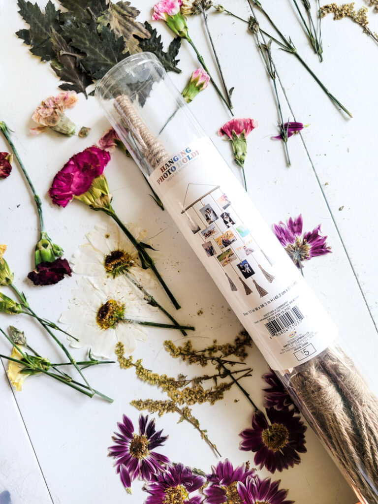 how to create dried flower wall art for budget-friendly decor that is feminine and sweet. This cozy vintage dorm room is a beautiful home away from home. Dried grocery store flowers came in handy to create this boho chic room decor! #dormdecor #driedflowers #DIYwallart