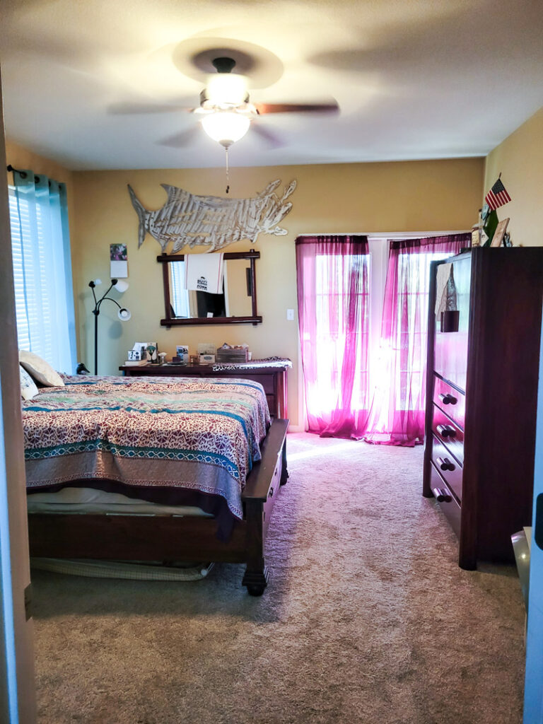 Master bedroom redo. Vintage paint color palette and budget curtain hack, get the look for less from Ballard Design. Buffalo check curtains make big impact for cheap. #greenbedroom #vintagebedroom #taxidermy #affordablecurtains