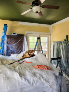 Master bedroom redo. Vintage paint color palette and budget curtain hack, get the look for less from Ballard Design. Buffalo check curtains make big impact for cheap. #greenbedroom #vintagebedroom #taxidermy #affordablecurtains