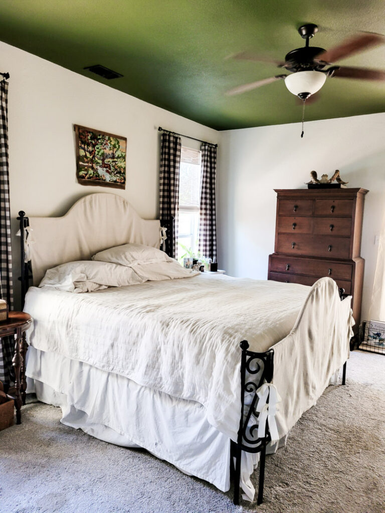 Master bedroom redo. Vintage paint color palette and budget curtain hack, get the look for less from Ballard Design. Buffalo check curtains make big impact for cheap. #greenbedroom #vintagebedroom #taxidermy #affordablecurtains