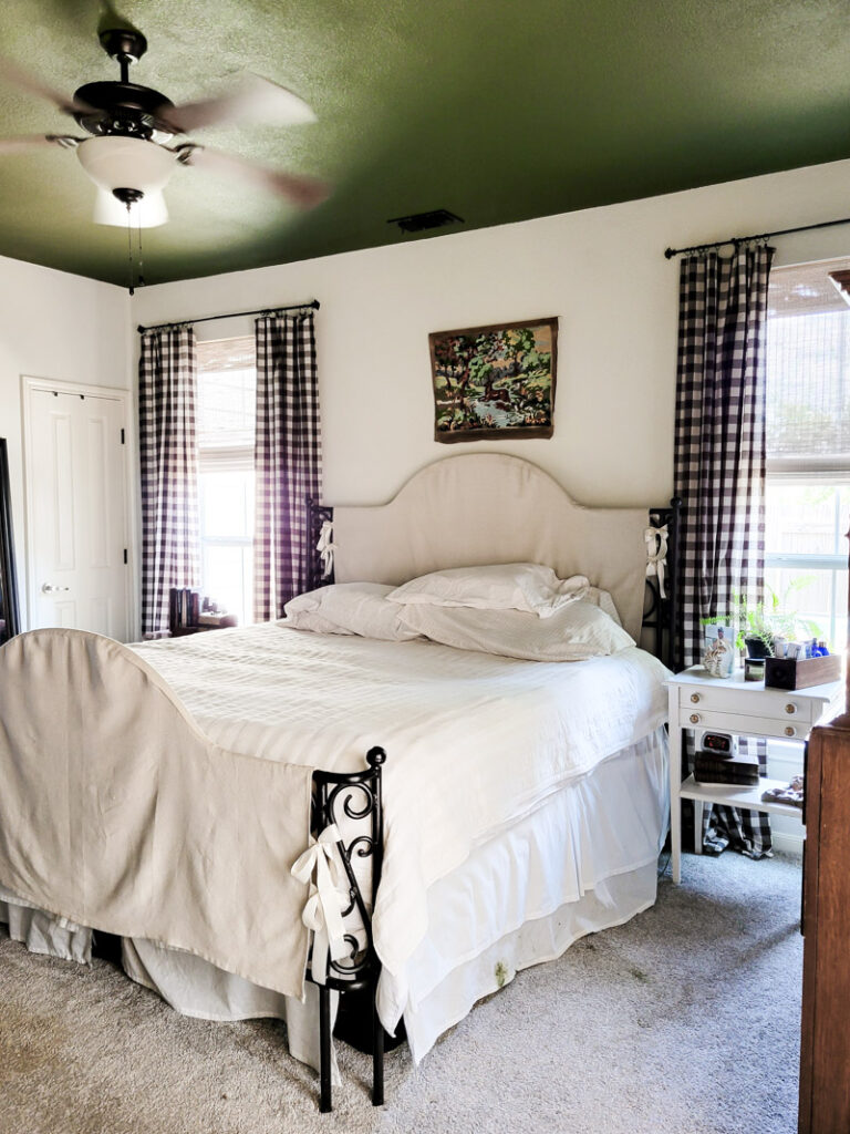 Master bedroom redo. Vintage paint color palette and budget curtain hack, get the look for less from Ballard Design. Buffalo check curtains make big impact for cheap. #greenbedroom #vintagebedroom #taxidermy #affordablecurtains