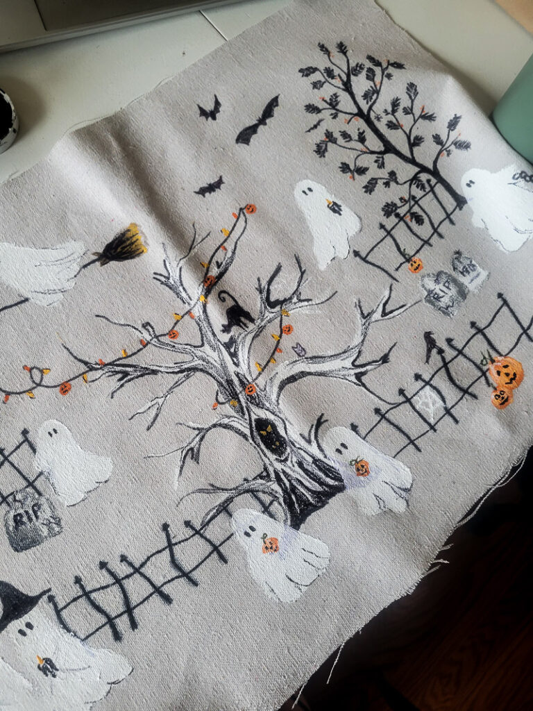 This scary squad halloween table runner would normally cost you $99... but I'm going to show you how to make it for $15 or less! Such a budget-friendly, fun project for Halloween. #halloweenDIY #halloweenproject #tablerunnerDIY #spookyDIY #budgetfriendlyhalloweendecor #cheaphalloweendecor #halloweendecordupe