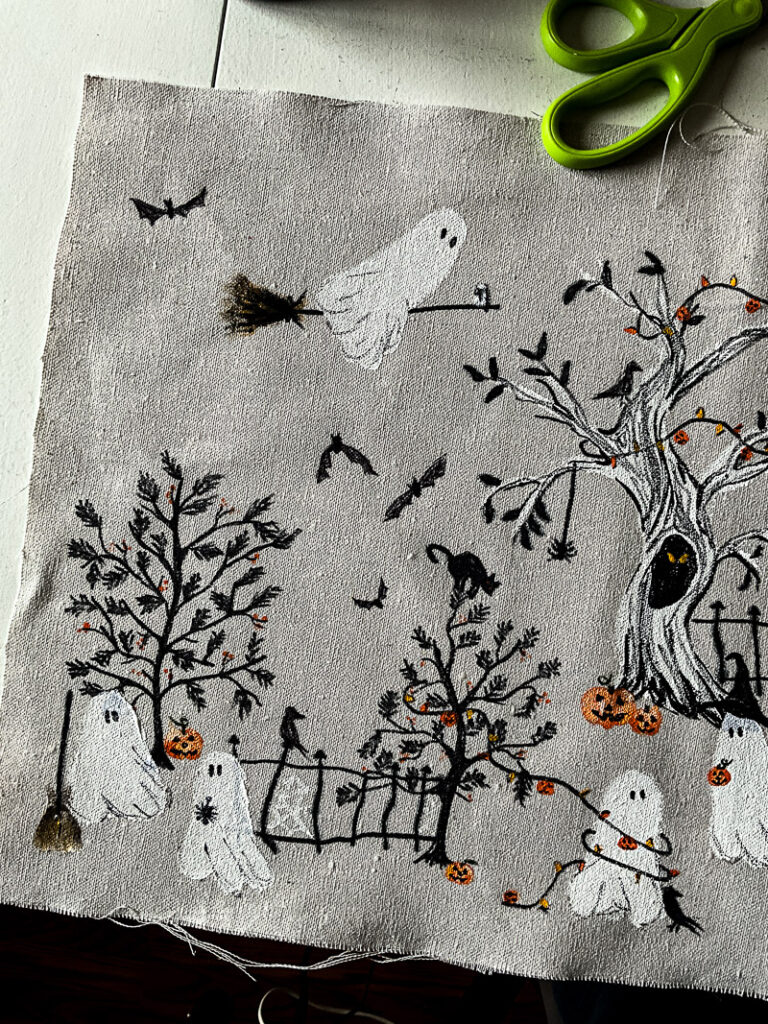 This scary squad halloween table runner would normally cost you $99... but I'm going to show you how to make it for $15 or less! Such a budget-friendly, fun project for Halloween. #halloweenDIY #halloweenproject #tablerunnerDIY #spookyDIY #budgetfriendlyhalloweendecor #cheaphalloweendecor #halloweendecordupe