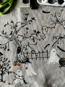 This scary squad halloween table runner would normally cost you $99... but I'm going to show you how to make it for $15 or less! Such a budget-friendly, fun project for Halloween. #halloweenDIY #halloweenproject #tablerunnerDIY #spookyDIY #budgetfriendlyhalloweendecor #cheaphalloweendecor #halloweendecordupe