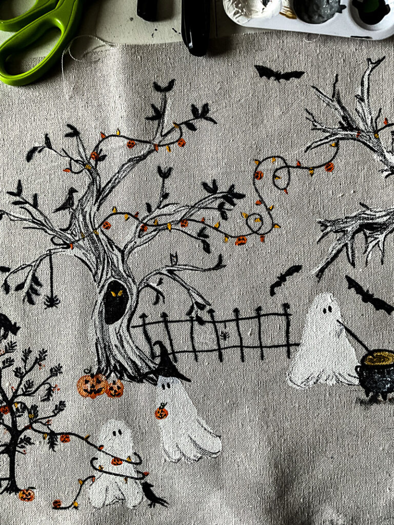 This scary squad halloween table runner would normally cost you $99... but I'm going to show you how to make it for $15 or less! Such a budget-friendly, fun project for Halloween. #halloweenDIY #halloweenproject #tablerunnerDIY #spookyDIY #budgetfriendlyhalloweendecor #cheaphalloweendecor #halloweendecordupe