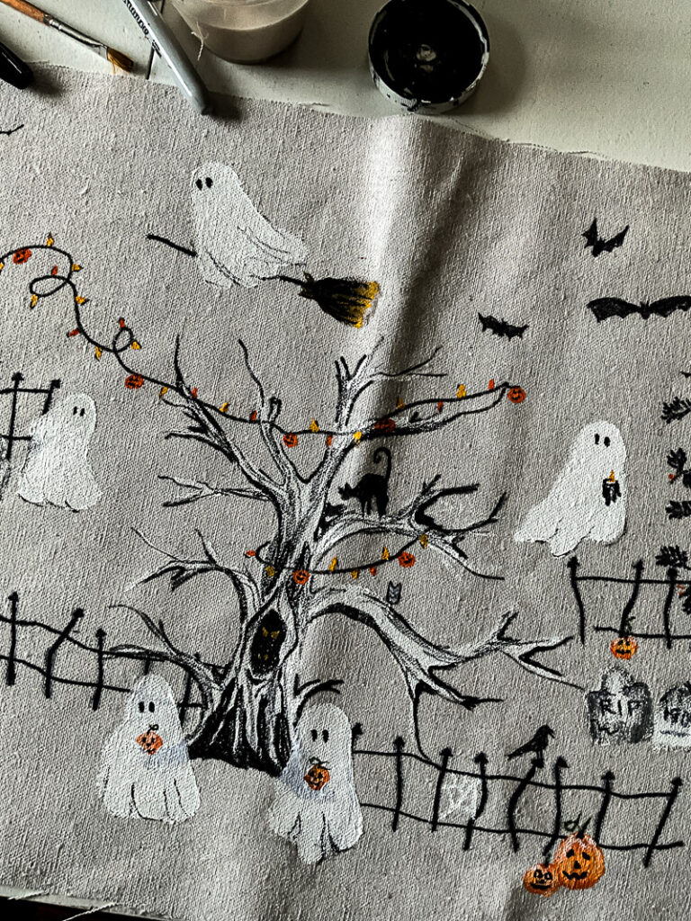 This scary squad halloween table runner would normally cost you $99... but I'm going to show you how to make it for $15 or less! Such a budget-friendly, fun project for Halloween. #halloweenDIY #halloweenproject #tablerunnerDIY #spookyDIY #budgetfriendlyhalloweendecor #cheaphalloweendecor #halloweendecordupe