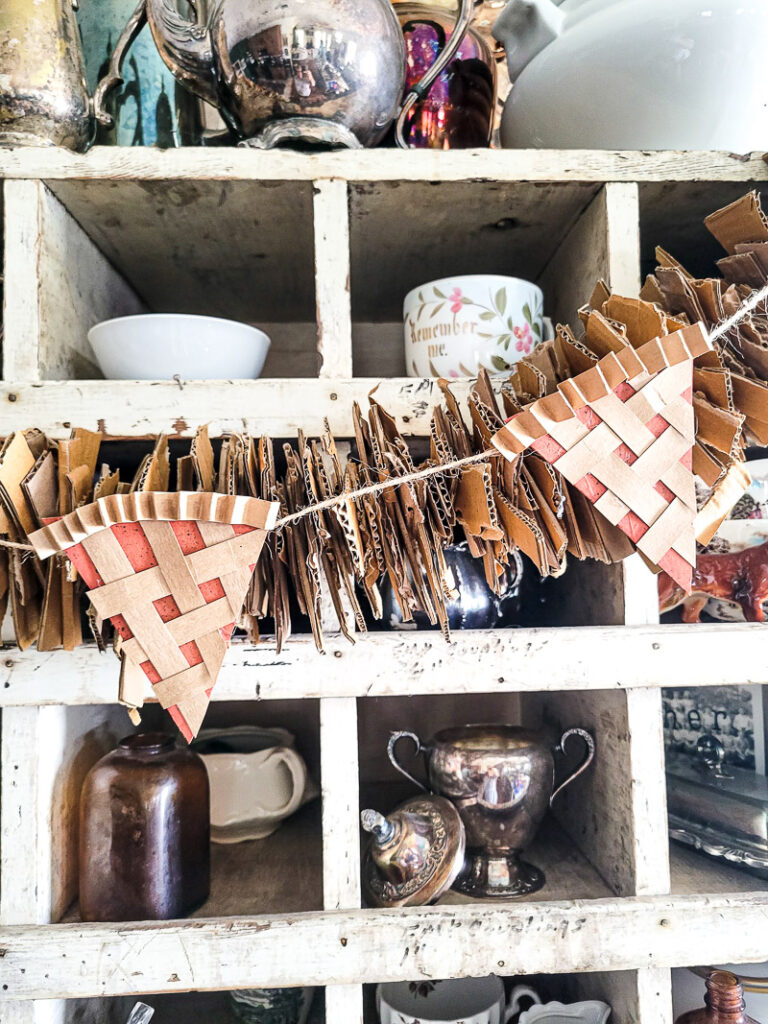 Keep your Fall decor in budget this year with this DIY pie garland made from cardboard and paper! So cute and easy!