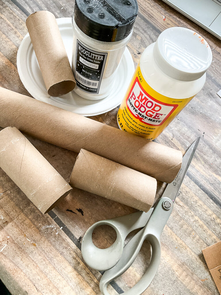 Here's how to turn toilet paper rolls into snowflakes and icicles to create your own budget-friendly winter wonderland! #toiletpaperroll #toiletpaperrolldiy #winterdecordiy