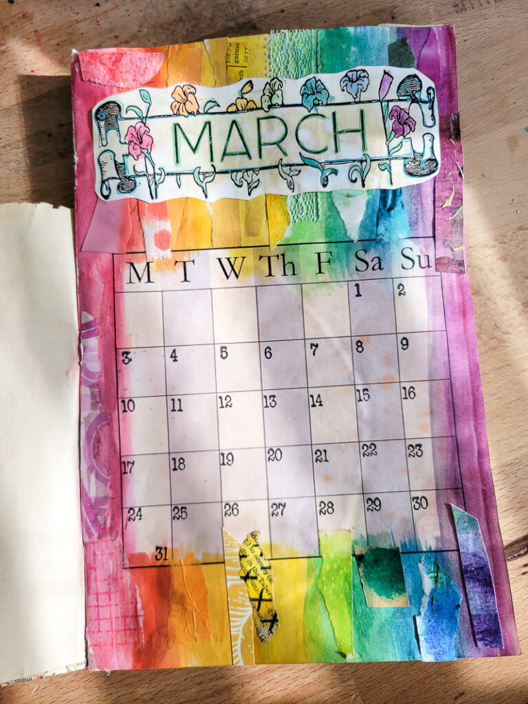 Junk journal calendar planner flip through for the month of March. Inspired by the rainbow this colorful imagery of God's promise is perfect for organizing my days in the one of a kind day planner I created! #journalgirl #calendarflip #junkjournalideas #mixedmediajournal